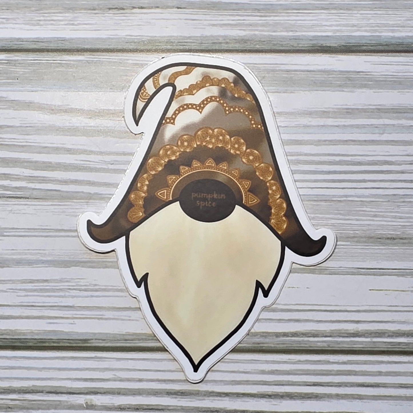 Gnome Head with the word Pumpkin spice on his nose, and the hat is decorated with tones of brown and zendoodle designs