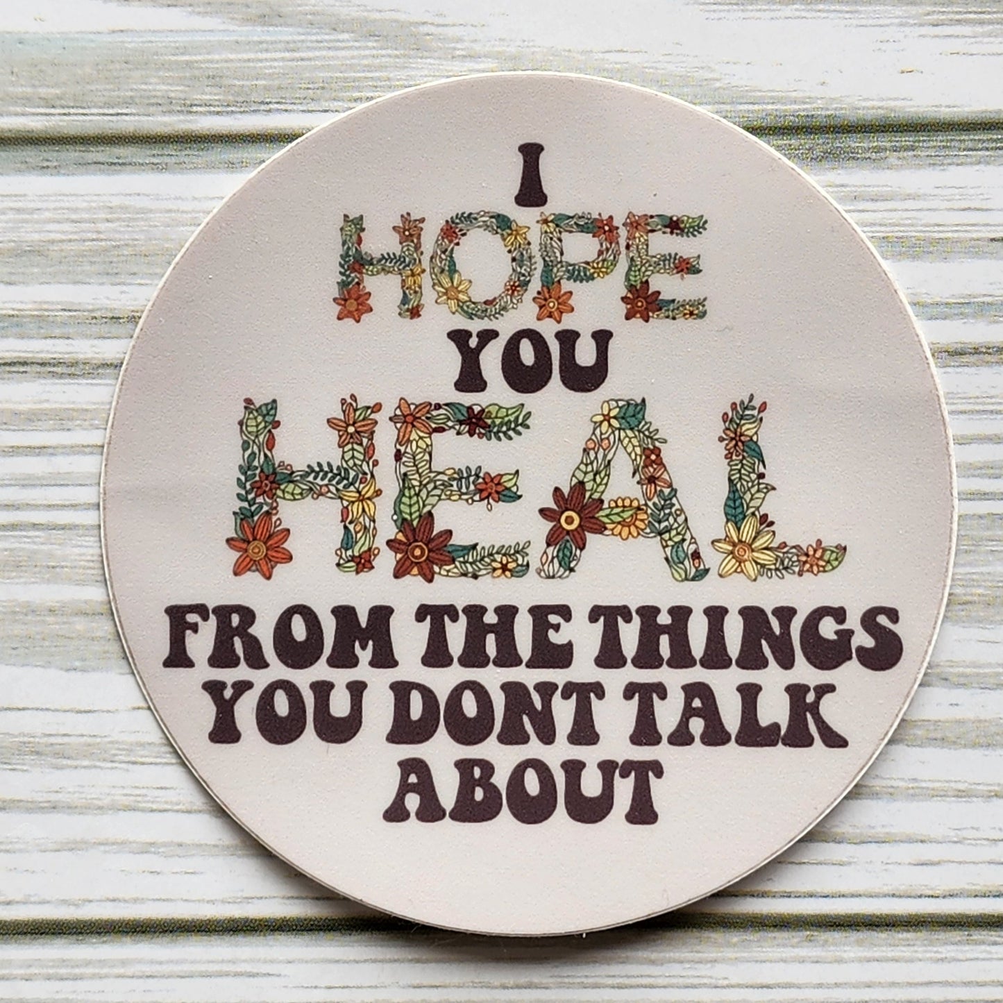 I Hope You Heal From The Things You Don't Talk About Circle Sticker with the words Hope and Heal made out of a hand drawn floral design in the shape of each letter.