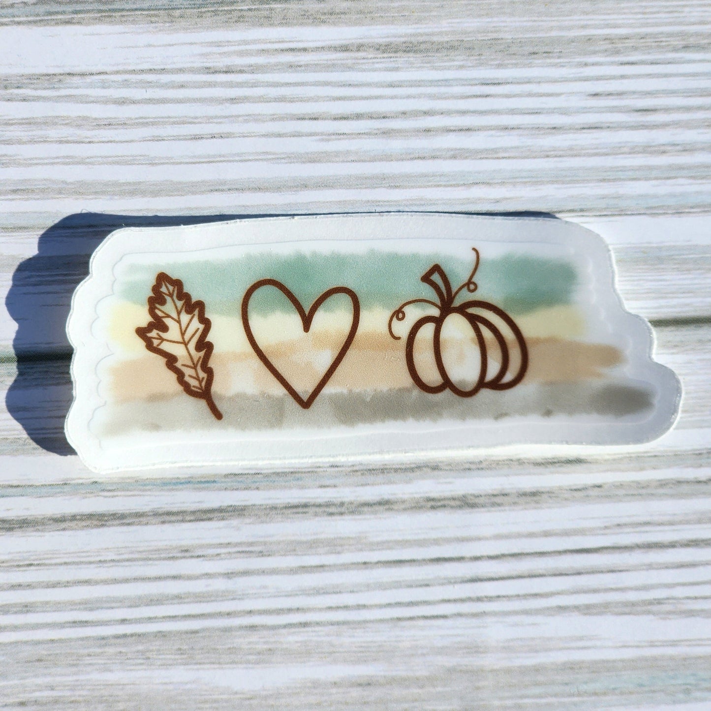 Minimal fall-themed sticker with pumpkin, heart, and leaf illustration on a transparent background.