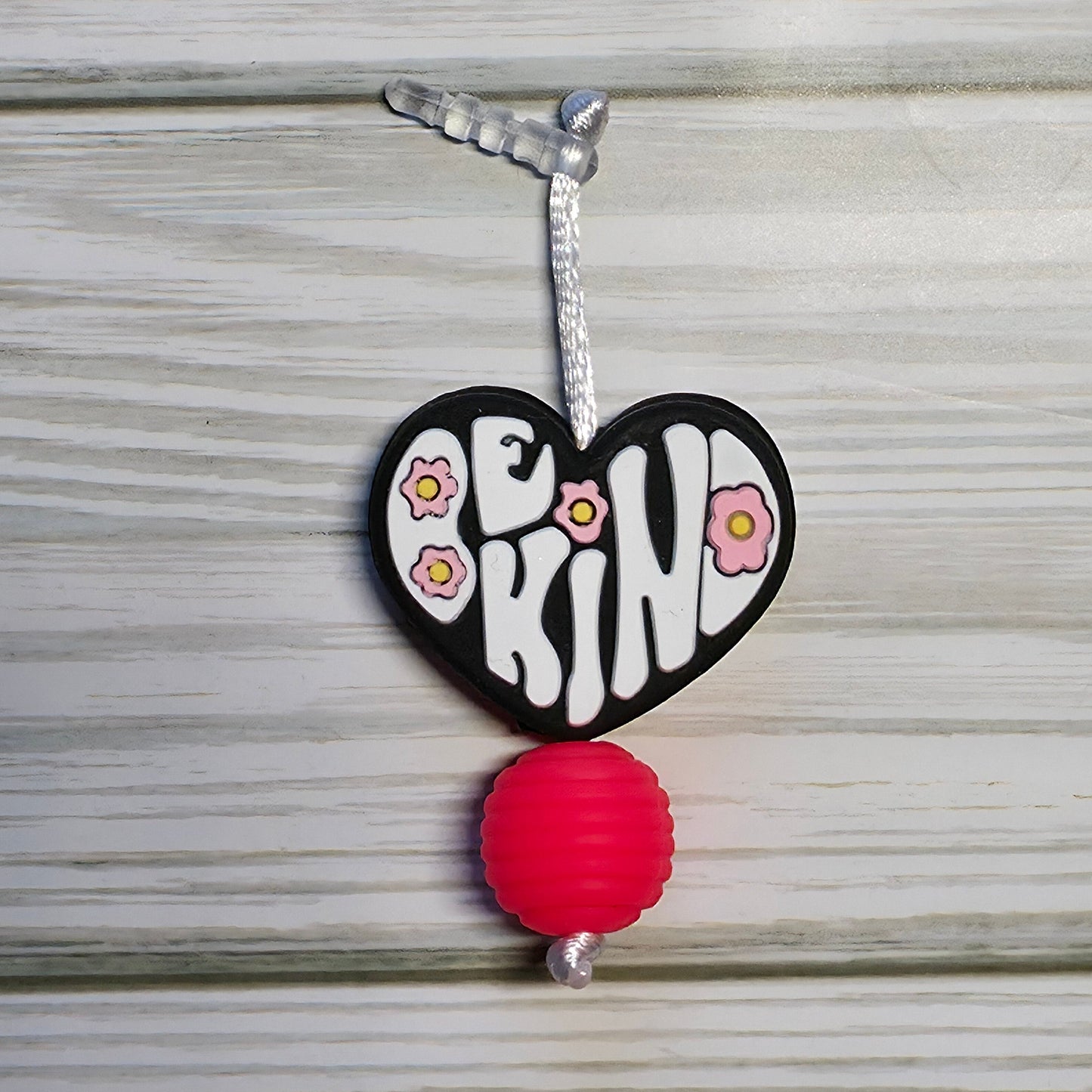 Handmade silicone Nintendo Switch charms in various colors and shapes, attached with white silky cords – designed to add charm without scratching the console.