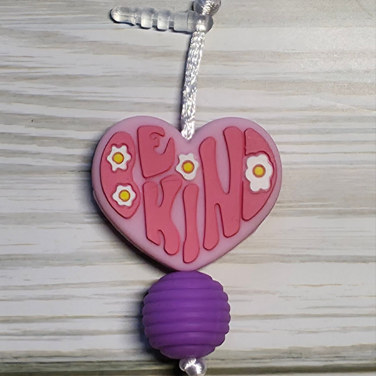 Handmade silicone Nintendo Switch charms in various colors and shapes, attached with white silky cords – designed to add charm without scratching the console.