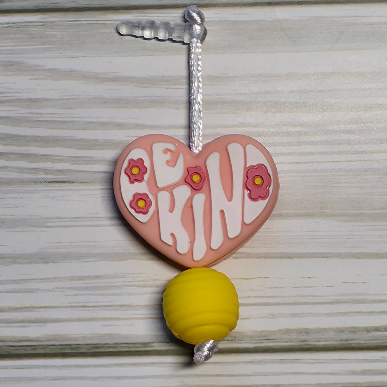 Handmade silicone Nintendo Switch charms in various colors and shapes, attached with white silky cords – designed to add charm without scratching the console.