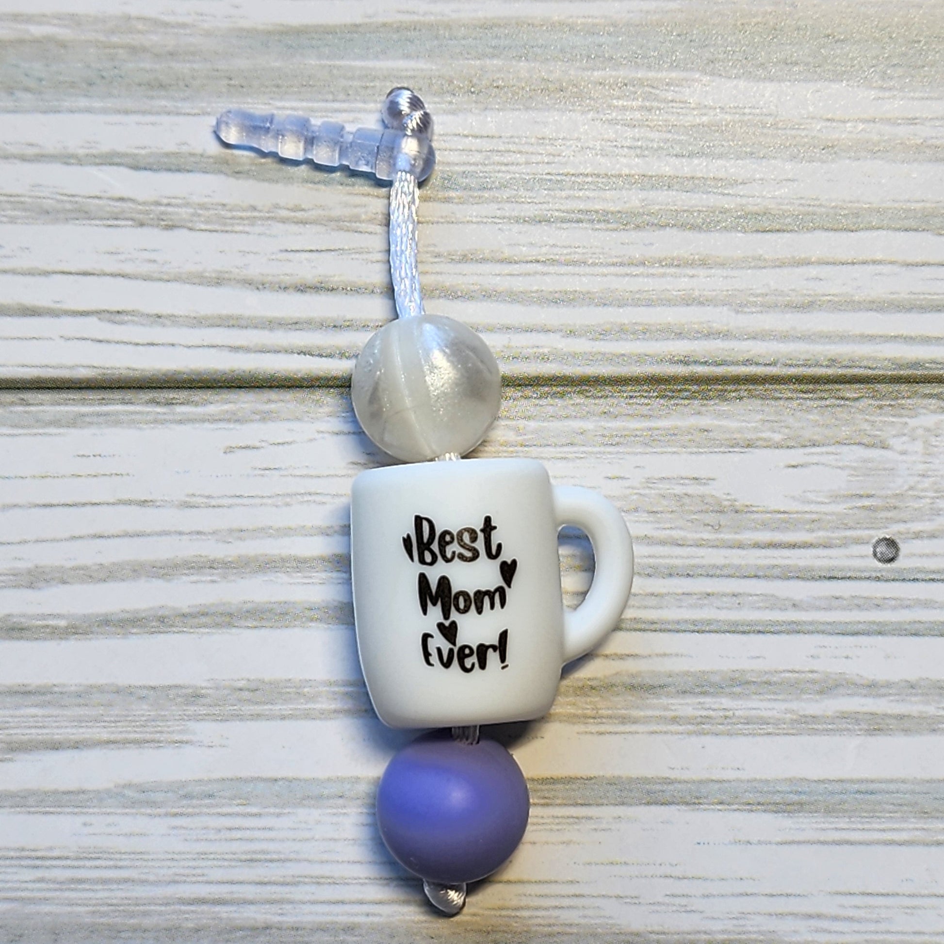 Handmade silicone Nintendo Switch charms in various colors and shapes, attached with white silky cords – designed to add charm without scratching the console.