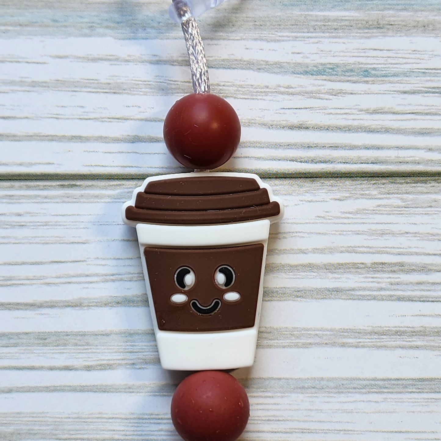 Handmade silicone Nintendo Switch charms in various colors and shapes, attached with white silky cords – designed to add charm without scratching the console.