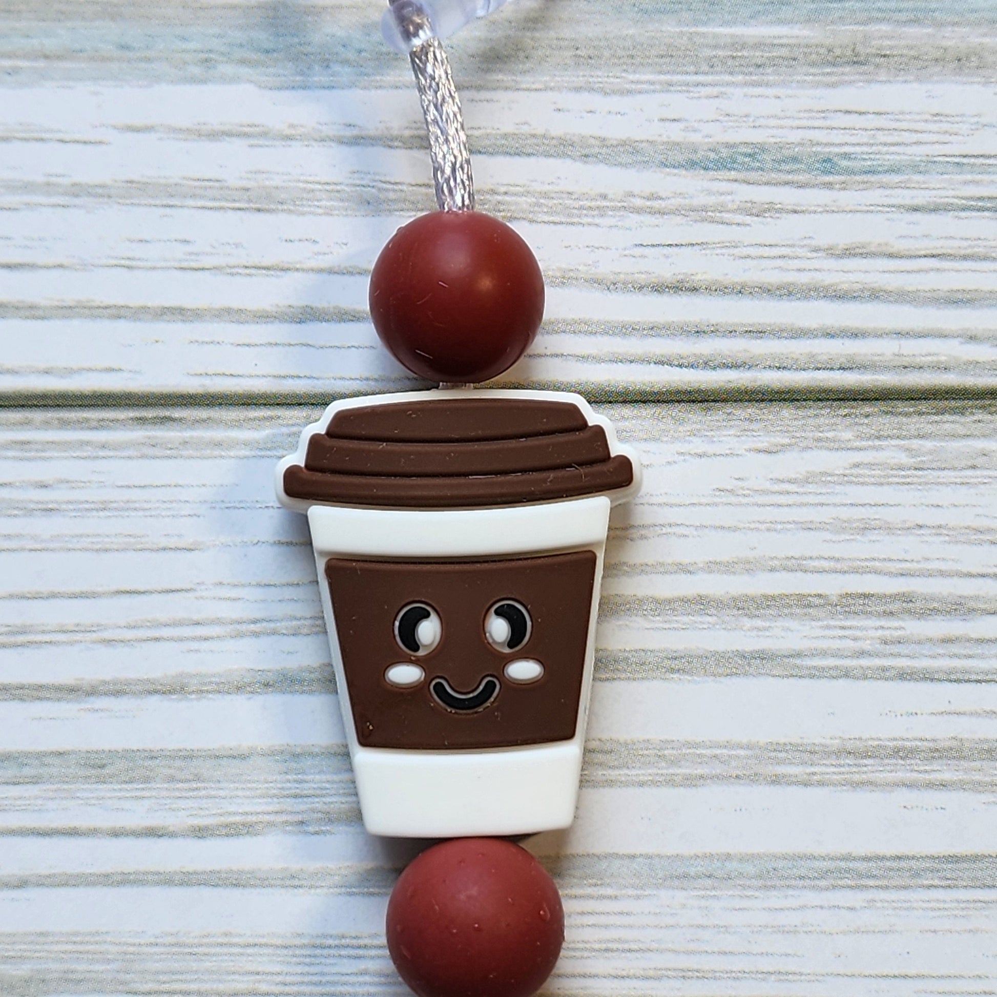 Handmade silicone Nintendo Switch charms in various colors and shapes, attached with white silky cords – designed to add charm without scratching the console.