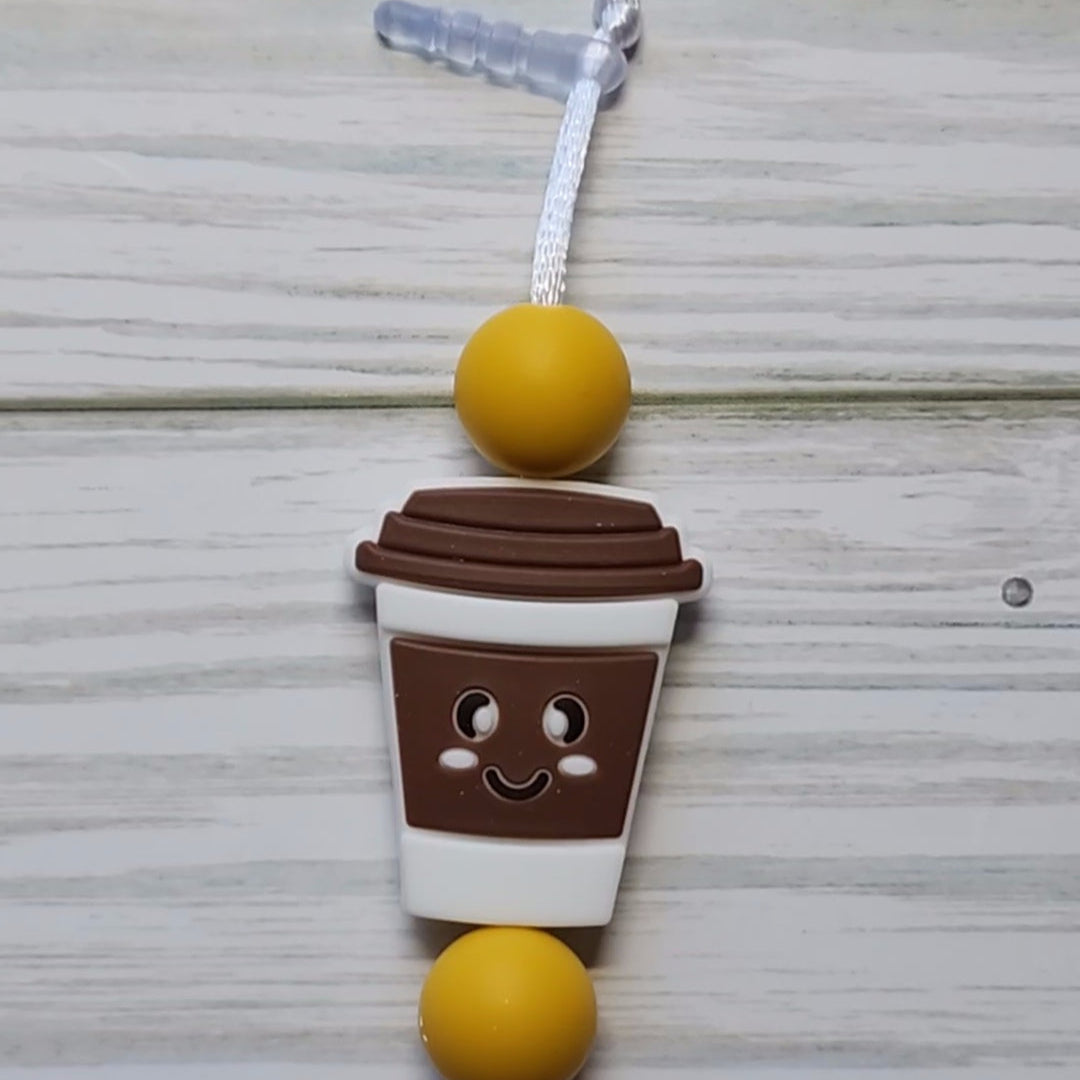 Handmade silicone Nintendo Switch charms in various colors and shapes, attached with white silky cords – designed to add charm without scratching the console.