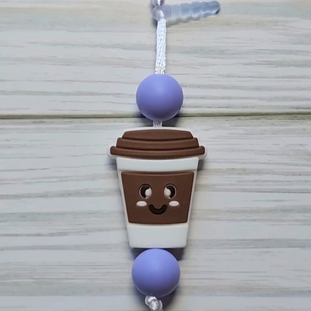 Handmade silicone Nintendo Switch charms in various colors and shapes, attached with white silky cords – designed to add charm without scratching the console.