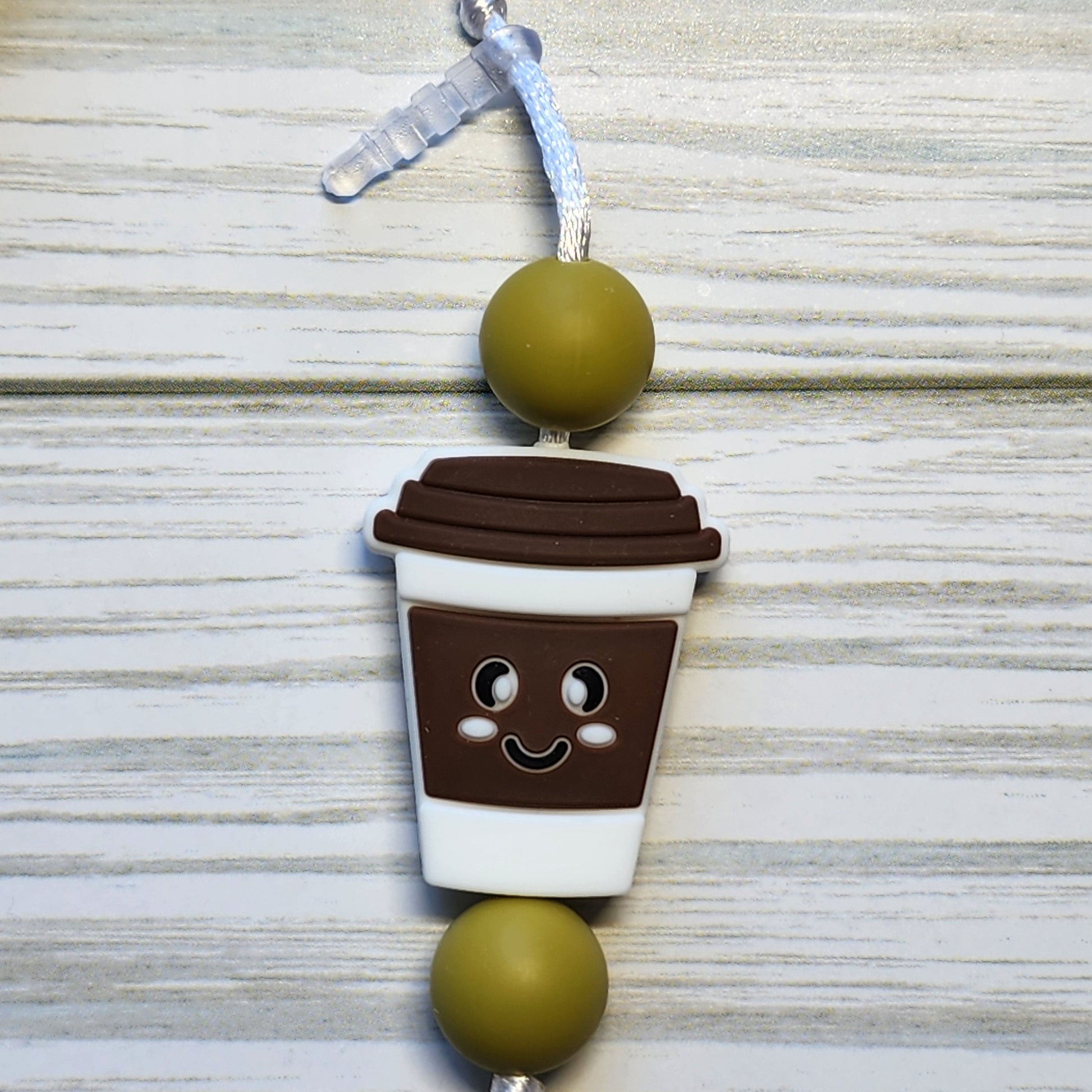 Handmade silicone Nintendo Switch charms in various colors and shapes, attached with white silky cords – designed to add charm without scratching the console.