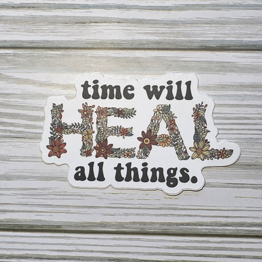 Typography design reading ‘Time Will Heal All Things,’ with the word ‘Heal’ in decorative floral lettering.